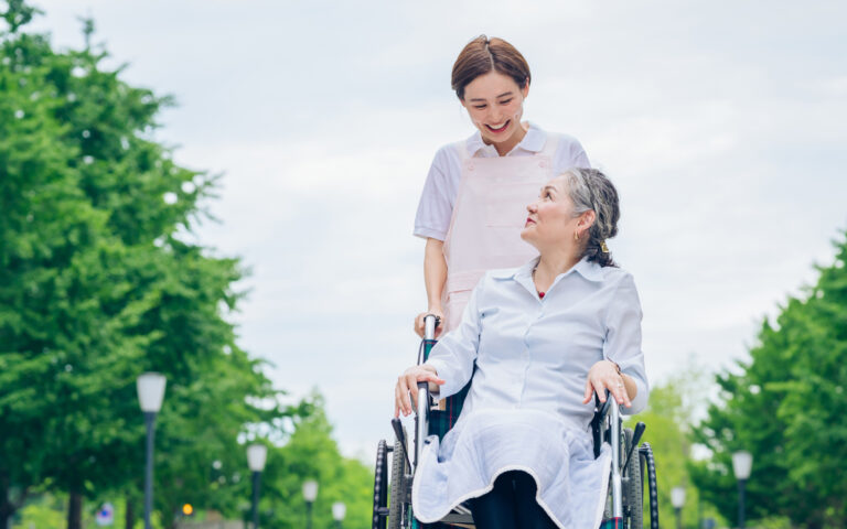 woman-wheelchair-young-woman-apron-care 1